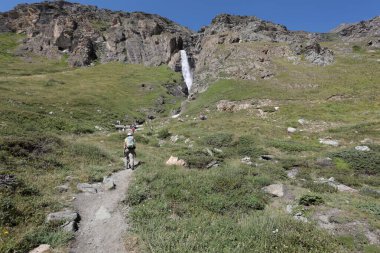 Aosta Valley, Italy - August 16, 2024: Hikers on the Val di Rhemes trail in the Gran Paradiso National Park. Aosta Valley, Italy. clipart