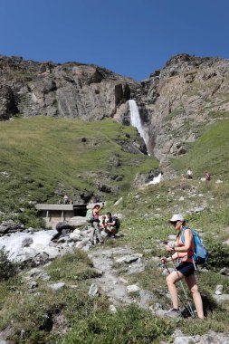 Aosta Valley, Italy - August 16, 2024: Hikers on the Val di Rhemes trail in the Gran Paradiso National Park. Aosta Valley, Italy. clipart