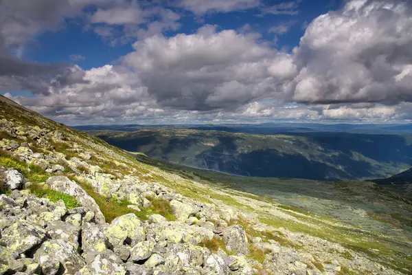 stock image Rocks on the slopes of the Gaustoppen mountain near Rjukan in Norway light up in warm sunlight