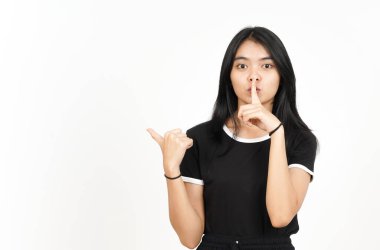 Shh gesture, Presenting and Pointing Side Product Using Thumb Of Beautiful Asian Woman Isolated