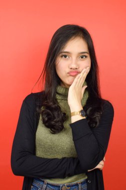 El Chin 'e ve Kızıl Arkaplanda tecrit edilmiş Güzel Asyalı Kadının Sıkıcı Jestine