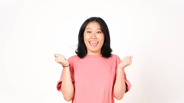 Young Asian woman in pink t-shirt yes cheerful gesture and smiling to the camera on isolated white background