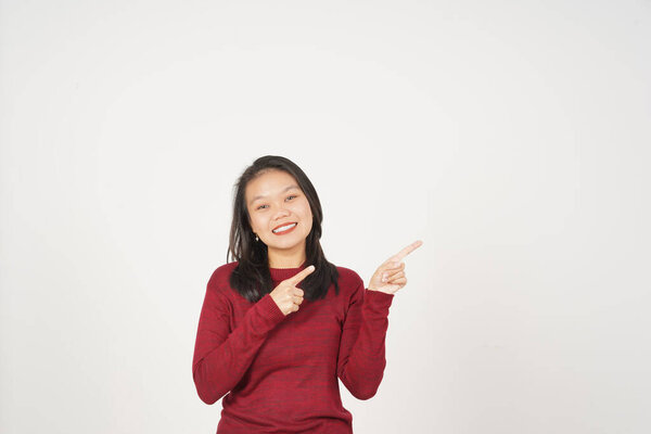 Young Asian woman in Red t-shirt pointing side copy space isolated on white background