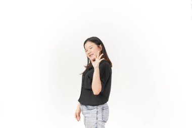 Beyaz arka planda siyah tişört ve kot pantolon giyen Asyalı genç bir kadın görülüyor.