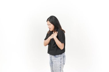 beautiful Asian woman holds her chest, displaying discomfort, against a clean white background