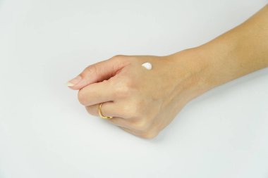 Kadın üzerinde nemlendirici krem uygulaması El beyaz arka planda izole edildi