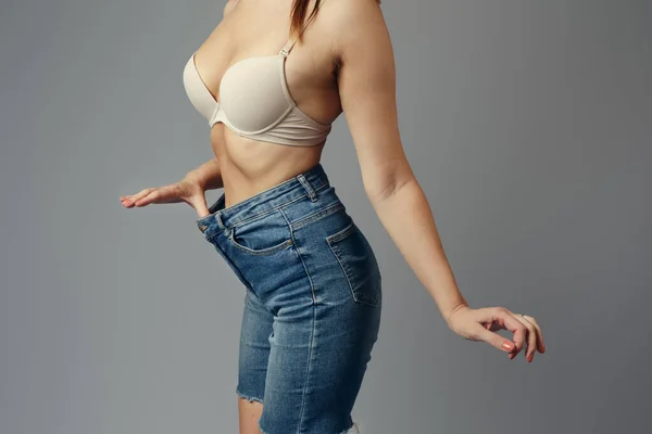 Woman wearing denim shorts with a beautiful waist stock photo