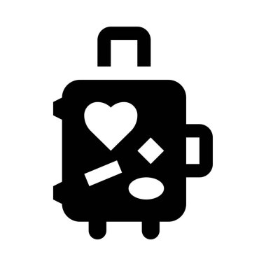 Üzerinde kalp ve çıkartma olan bir bavul.