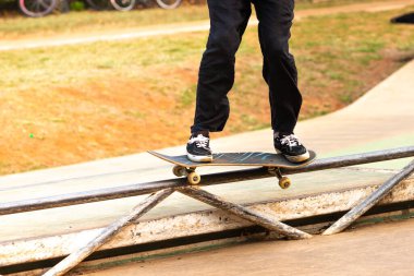 Skateboarder performing the fifty maneuver. clipart