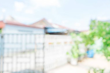 Beyaz çitin dışındaki birkaç evin soyutlanmış arka planı. Bulanık konut alanı arkaplanı