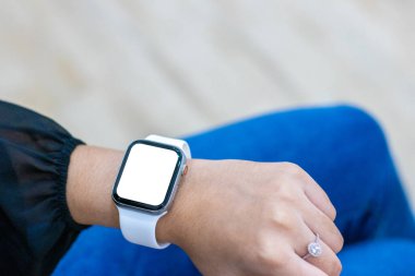 Model için beyaz, boş, akıllı bir saate bakan bir kadının görüntüsü