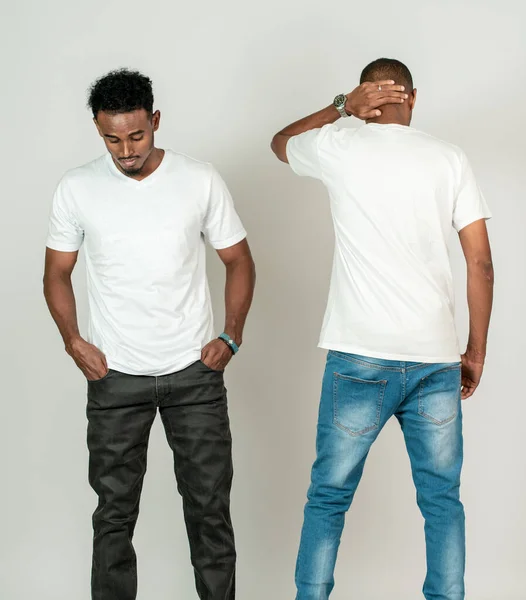 Two african man doing a simple pose with one facing back and the other facing front on the white background