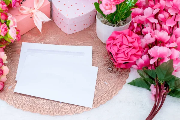 Rectangle greeting card above an rounded tablecloth surrounded by colorful decoration with valentine themed, and a white fluffy carpet as the background