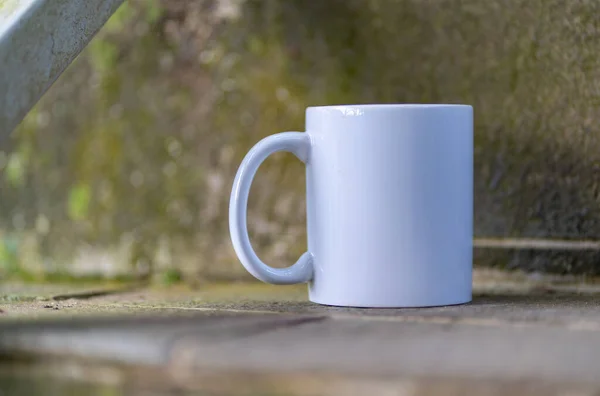 White blank coffee mug with out of focus foreground and background, coffee mug mockup image