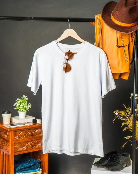 A minimalist v-neck shirt mockup, boasting a refined aesthetic with subtle decoration, presented in a hanging position for maximum impact
