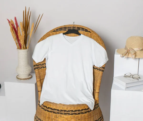 The v-neck shirt mockup presents a garment adorned with minimalist decoration, elegantly hung for display