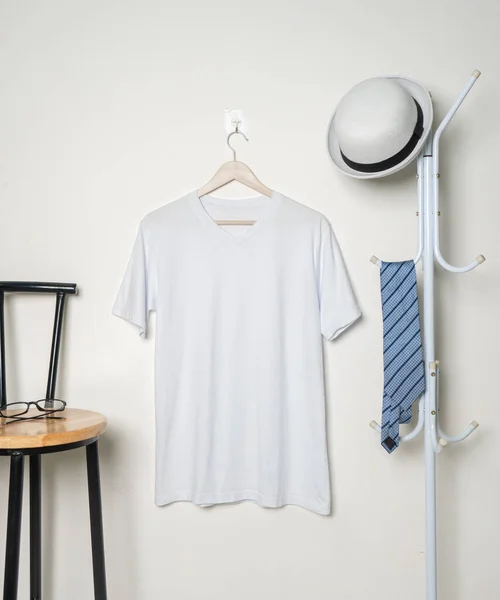 The v-neck shirt featured in the mockup showcases a simplistic yet stylish design, hanging beautifully to showcase its understated appeal