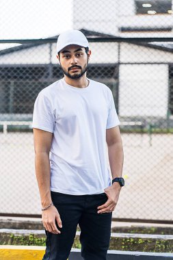 Sakallı yüzü ve şık kıyafetiyle bu adam kendine güven ve güç saçan bir poz veriyor. Beyaz boş şapka ve gömlek modeli.