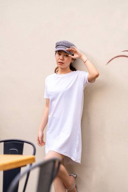 Asyalı model, basit bir ortamda çarpıcı bir portre için poz veriyor, gömlek modeli şablon resmi