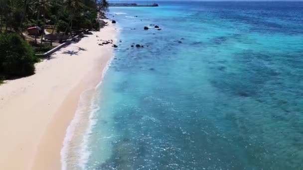 stock video Aerial footage of the blue colored sea water swashing over a beach, taken with a drone