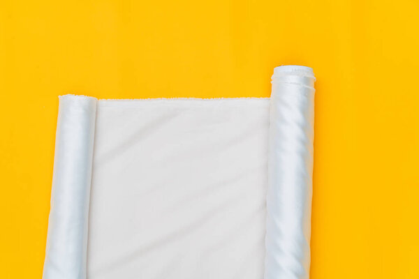 The subtle charm of a glossy white fabric roll image is brought to life in this minimalistic mockup presentation