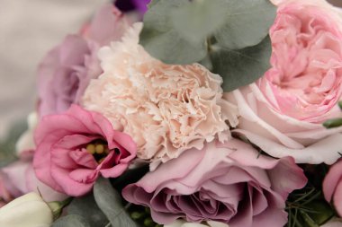 Wedding bouquet of different flowers. Details of the wedding ceremony.