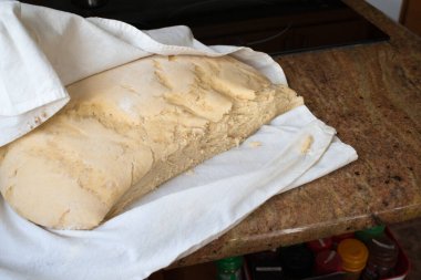 Casadielles dough after rising, protected by a table cloth. Interior