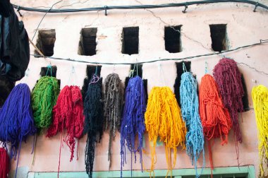 Multicolored skeins of wool hanging in a rope. Morocco