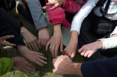 Approaching hands of a group of friends with mountain clothes. Iceland