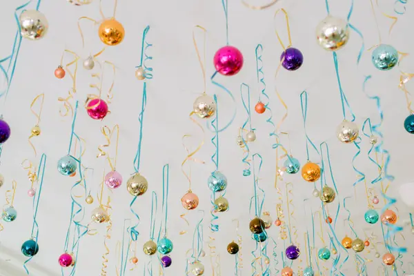 Colorful background for a party. Christmas balls and ribbons