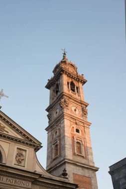 Bell tower of Bernascone with beautiful light  in Varese, Italy clipart
