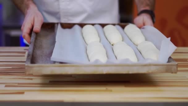 Raw Long Buns Parchment Paper Baking Oven Male Baker White — Stock Video