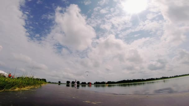 Skydiver Flies Blue Parachute Lake Approaching Ground Sportsman Uses Parachute — Stock Video