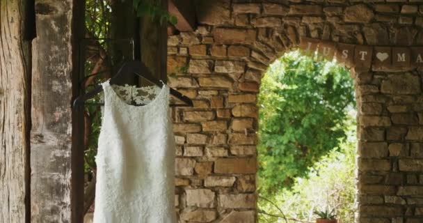 White Wedding Dress Hanging Wooden Column Ancient Italian Terrace Illuminated — Stock Video