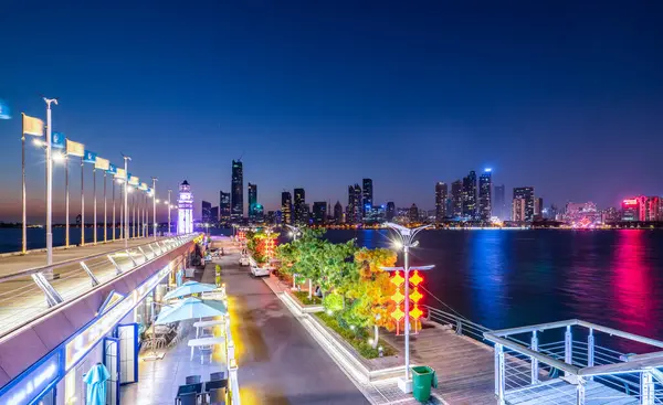 stock image White lighthouse and urban architecture landscape night view