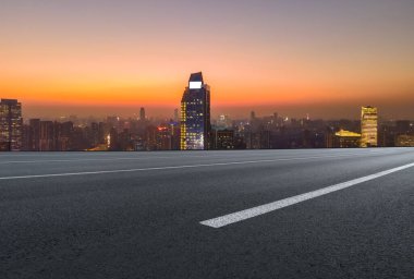 Panoramik ufuk çizgisi ve modern binalarla dolu boş asfalt yol