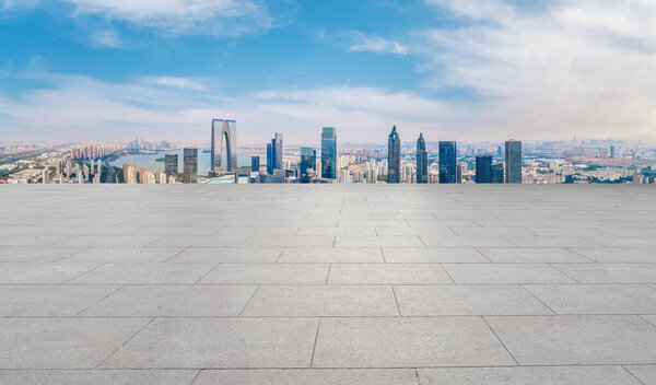 Empty brick floor with city skyline background