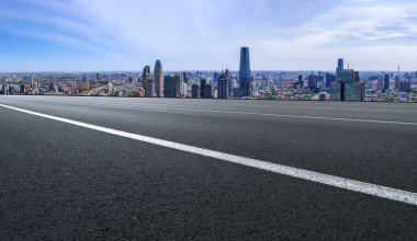 Panoramik ufuk çizgisi ve modern binalarla dolu boş asfalt yol