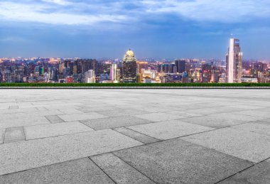 Boş tuğla zemin ve şehrin ufuk çizgisi arka planı