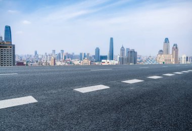 Panoramik ufuk çizgisi ve modern binalarla dolu boş asfalt yol