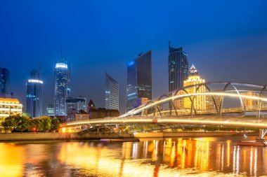 Night view of modern architecture street along Haihe River in Ti clipart