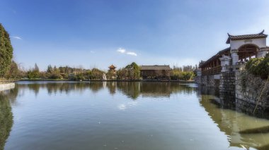 Kunming ethnic village Chinese garden lake natural scenery clipart