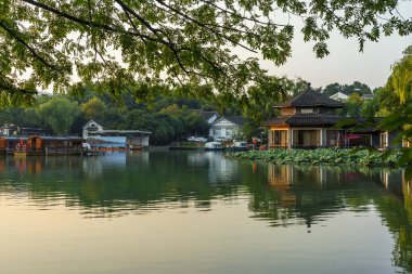 Hangzhou West Lake Chinese garden scenery at sunset clipart