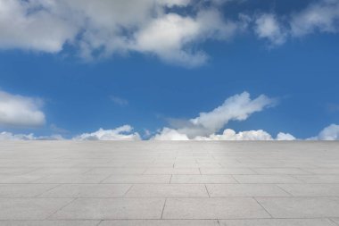 Floor tiles and natural scenery of blue sky and white clouds clipart