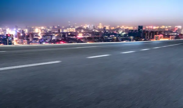 stock image Night scene of road traffic and city buildings