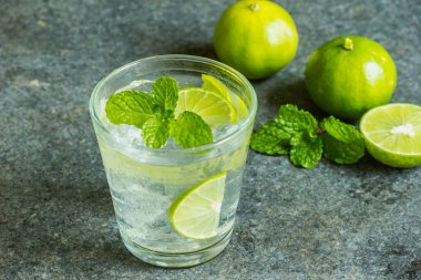 Fresh fruit juices, lemonades, refreshments and a glass of lime slides Lime and mint leaves