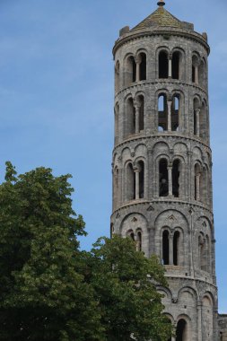 Vertical summer outdoor closeup on the mediaeval Fenestrelle bell tower of the Catherdral of Uzes, Gard , France clipart