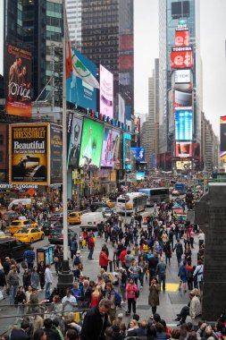 A bustling scene in Times Square, New York City, filled with crowds of people, yellow taxis, and bright advertisements. Skyscrapers tower in the background, showcasing the vibrant urban atmosphere. clipart