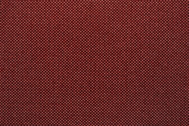 Döşeme kumaşı ve arka plan kirli bordo renginde. Kumaş dokusu arkaplan ve tasarım ögesi olarak. Kanepe için kumaş dokusu