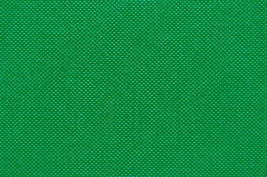 Döşeme kumaşının yeşil renkli dokusu ve arka planı. Kumaş dokusu arkaplan ve tasarım ögesi olarak. Kanepe için kumaş dokusu